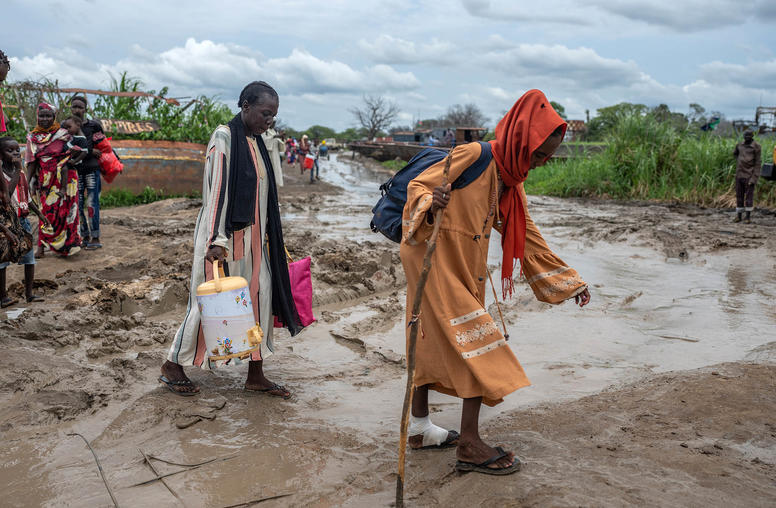 **EMBARGO: No electronic distribution, Web posting or street sales before 12:01 a.m. ET Thursday, Sept. 7, 2023. No exceptions for any reasons. EMBARGO set by source.** Refugees that fled fighting in Sudan head towards a barge in Renk, South Sudan before being relocated to their place of origin, on Aug. 27, 2023. Tens of thousands   fled a grisly civil conflict years ago to settle in Sudan, to the north. With war now raging there, they are streaming home to a country ill-prepared to take them back. (Joao Silva/The New York Times)